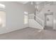 Open living room with high ceilings, neutral paint, staircase and carpet flooring at 5402 Shady Lair Ct, North Las Vegas, NV 89031