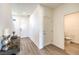 Bright hallway showcasing neutral wall paint, wood floors, and a convenient half bathroom at 549 Ruby Robin Ave # 751, Henderson, NV 89011