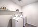 This is a laundry room with a washer and dryer and shelving for storage at 549 Ruby Robin Ave # 751, Henderson, NV 89011