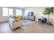 Spacious living room featuring neutral wall paint, wood floors, and a gray area rug at 549 Ruby Robin Ave # 751, Henderson, NV 89011