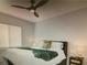 This bedroom features a ceiling fan, plush bedding, and bedside tables at 5888 Becklow Gardens Ave, Las Vegas, NV 89141