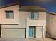 Two-story home boasts a modern design with a front-facing garage and a bright blue front door at 5888 Becklow Gardens Ave, Las Vegas, NV 89141
