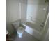 Bathroom featuring a white toilet, tub, and laminate countertop with modern fixtures at 5969 High Steed St # 101, Henderson, NV 89011