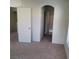 Clean interior view showcasing neutral tones with both an arched doorway and standard door at 5969 High Steed St # 101, Henderson, NV 89011