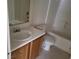 Standard bathroom featuring a white toilet, tub, and laminate countertop with modern fixtures at 5969 High Steed St # 101, Henderson, NV 89011