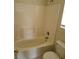 Bathroom featuring a white toilet, tub, and laminate countertop with modern fixtures at 5969 High Steed St # 101, Henderson, NV 89011