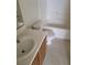 Bathroom featuring a white toilet, tub, and laminate countertop with modern fixtures at 5969 High Steed St # 101, Henderson, NV 89011