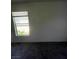Bedroom with a window that allows for natural lighting with neutral walls and flooring at 5969 High Steed St # 101, Henderson, NV 89011