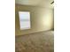 This bedroom boasts a comfortable carpet and an ample window for natural light at 5969 High Steed St # 101, Henderson, NV 89011