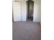 View of a bedroom featuring neutral walls and flooring and an en-suite bathroom at 5969 High Steed St # 101, Henderson, NV 89011