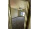 Bedroom with a ceiling fan and light fixture, a window, and neutral walls and carpeting at 5969 High Steed St # 101, Henderson, NV 89011