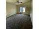 Spacious bedroom with a ceiling fan and natural light from the window at 5969 High Steed St # 101, Henderson, NV 89011