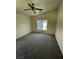 View of bedroom featuring neutral walls and carpeting, a window, and a ceiling fan with light fixture at 5969 High Steed St # 101, Henderson, NV 89011