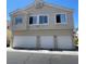 Three-story townhome featuring a stucco exterior and a three-car garage at 5969 High Steed St # 101, Henderson, NV 89011