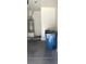 Garage of townhome showing a water heater, and a blue trash receptacle at 5969 High Steed St # 101, Henderson, NV 89011