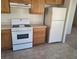 Efficient kitchen featuring wooden cabinetry and white appliances at 5969 High Steed St # 101, Henderson, NV 89011