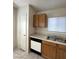 Functional kitchen featuring warm wood cabinetry and updated appliances at 5969 High Steed St # 101, Henderson, NV 89011