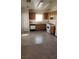 Full kitchen view featuring ample wooden cabinetry and standard white appliances at 5969 High Steed St # 101, Henderson, NV 89011