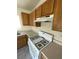 Bright kitchen featuring gas range, wooden cabinets, and neutral countertops at 5969 High Steed St # 101, Henderson, NV 89011
