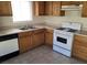 Close up of the kitchen showing the cabinets, oven, and double sink at 5969 High Steed St # 101, Henderson, NV 89011