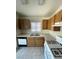 Kitchen with light countertops, wood cabinets and white appliances at 5969 High Steed St # 101, Henderson, NV 89011
