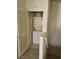 Stacked washer and dryer unit in a small laundry closet with access door at 5969 High Steed St # 101, Henderson, NV 89011