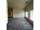 Living room with multiple windows for natural light, neutral walls and carpeted flooring at 5969 High Steed St # 101, Henderson, NV 89011