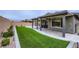 Great backyard with artificial turf and covered patio, perfect for outdoor enjoyment at 6519 Summershade St, North Las Vegas, NV 89086
