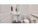 Charming powder room features a pedestal sink, oval mirror, and modern fixtures at 6519 Summershade St, North Las Vegas, NV 89086