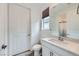 Bright bathroom featuring a white vanity with sink, large mirror, and modern fixtures at 6519 Summershade St, North Las Vegas, NV 89086