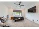This bedroom features plush carpeting, a modern ceiling fan, and a sleek, wall-mounted TV for ultimate comfort at 6519 Summershade St, North Las Vegas, NV 89086