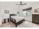 Bedroom with soft carpeting, a large window, ceiling fan and tasteful décor at 6519 Summershade St, North Las Vegas, NV 89086