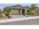 Charming single-story home featuring desert landscaping, a two-car garage and brick paved driveway at 6519 Summershade St, North Las Vegas, NV 89086