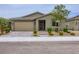 Lovely single-story home with well-maintained landscaping, a two-car garage, and a paved driveway and walkway at 6519 Summershade St, North Las Vegas, NV 89086