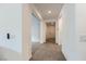 Bright hallway featuring tiled flooring leading to various rooms, creating a seamless transition throughout the home at 6519 Summershade St, North Las Vegas, NV 89086