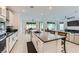 Spacious kitchen with a large island, stainless steel appliances, white cabinets, and an open floor plan at 6519 Summershade St, North Las Vegas, NV 89086