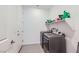 Convenient laundry room with modern washer and dryer, plus shelving for storage at 6519 Summershade St, North Las Vegas, NV 89086
