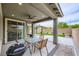 Enjoy outdoor dining on this spacious covered patio with ceiling fan and views of the backyard at 6519 Summershade St, North Las Vegas, NV 89086