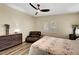 Bedroom with a ceiling fan, natural light, and a cozy reading chair at 6647 Montezuma Castle Ln, North Las Vegas, NV 89084