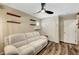 Cozy bedroom with modern ceiling fan, floating shelves, and plush sofa for ultimate relaxation at 6647 Montezuma Castle Ln, North Las Vegas, NV 89084