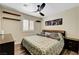 Comfortable bedroom with a ceiling fan, natural light from a window, and a cozy bed with stylish bedding at 6647 Montezuma Castle Ln, North Las Vegas, NV 89084