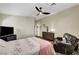 Bedroom featuring a ceiling fan, dresser, television, and comfortable seating area at 6647 Montezuma Castle Ln, North Las Vegas, NV 89084