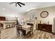 Open dining area features wood floors, a table, and a fireplace with a mantel at 6647 Montezuma Castle Ln, North Las Vegas, NV 89084