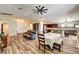 Open concept dining room and kitchen area with wood floors and an island with stool seating at 6647 Montezuma Castle Ln, North Las Vegas, NV 89084