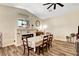 Bright dining room featuring fireplace, wood floors and dining table set for six at 6647 Montezuma Castle Ln, North Las Vegas, NV 89084