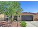 Charming single story home featuring a desert landscaped yard and decorative security screen door at 6647 Montezuma Castle Ln, North Las Vegas, NV 89084