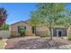 Inviting single story home showcasing desert landscaping, with an iron screen door at 6647 Montezuma Castle Ln, North Las Vegas, NV 89084