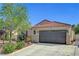 Inviting single story home showcasing desert landscaping, a brown garage door, and decorative shutters at 6647 Montezuma Castle Ln, North Las Vegas, NV 89084