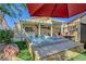 Backyard featuring a hot tub, covered patio, and well-manicured landscaping, perfect for outdoor entertaining at 6647 Montezuma Castle Ln, North Las Vegas, NV 89084