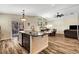 Open concept kitchen island overlooking fireplace and dining room and outdoor patio at 6647 Montezuma Castle Ln, North Las Vegas, NV 89084